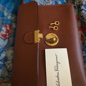 Gancini lock Ferragamo pebbled leather maroon clutch/wristlet.